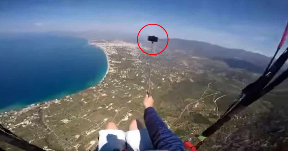 Gut-Wrenching Moment A Paraglider Drops His Phone While Taking Selfie